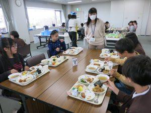 ワイワイと楽しみながら給食を食べる生徒たちの写真