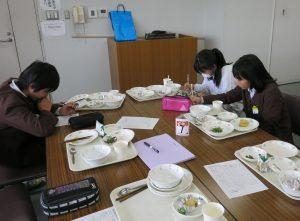振り返りシートに食べた量を記録する生徒たちの写真