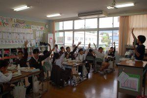 学生たちが手を挙げて、米クイズを参加している写真