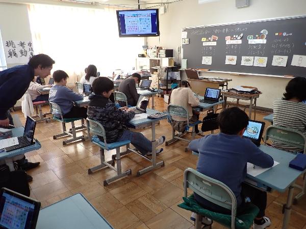 タブレットを使って教材プリントを見る5年生