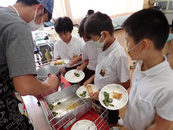ピリカラきゅうりのおかわりに集まる赤阪小学校5年生